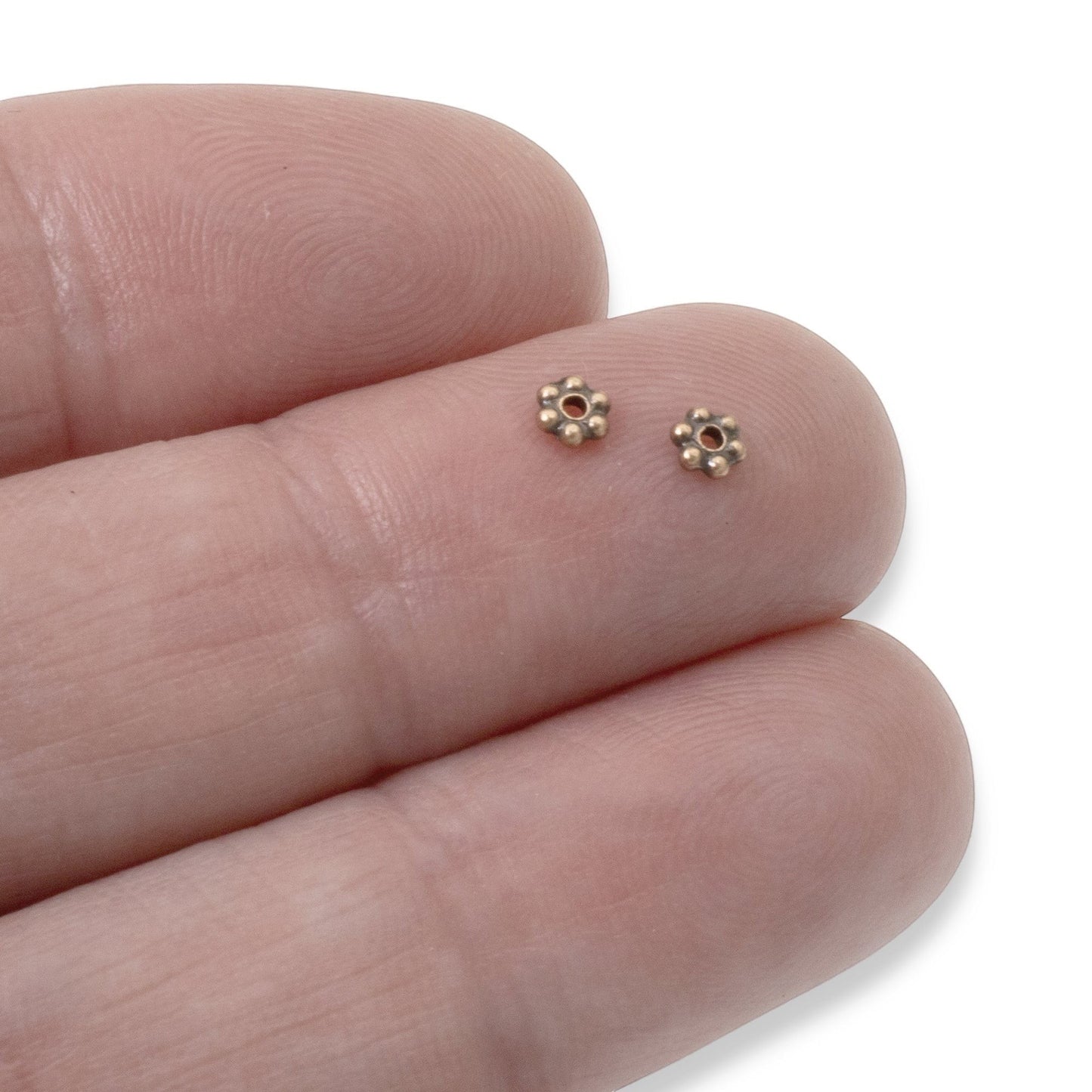 Hackberry Creek antique copper 3mm daisy spacer beads with TierraCast design, ideal for boho jewelry.