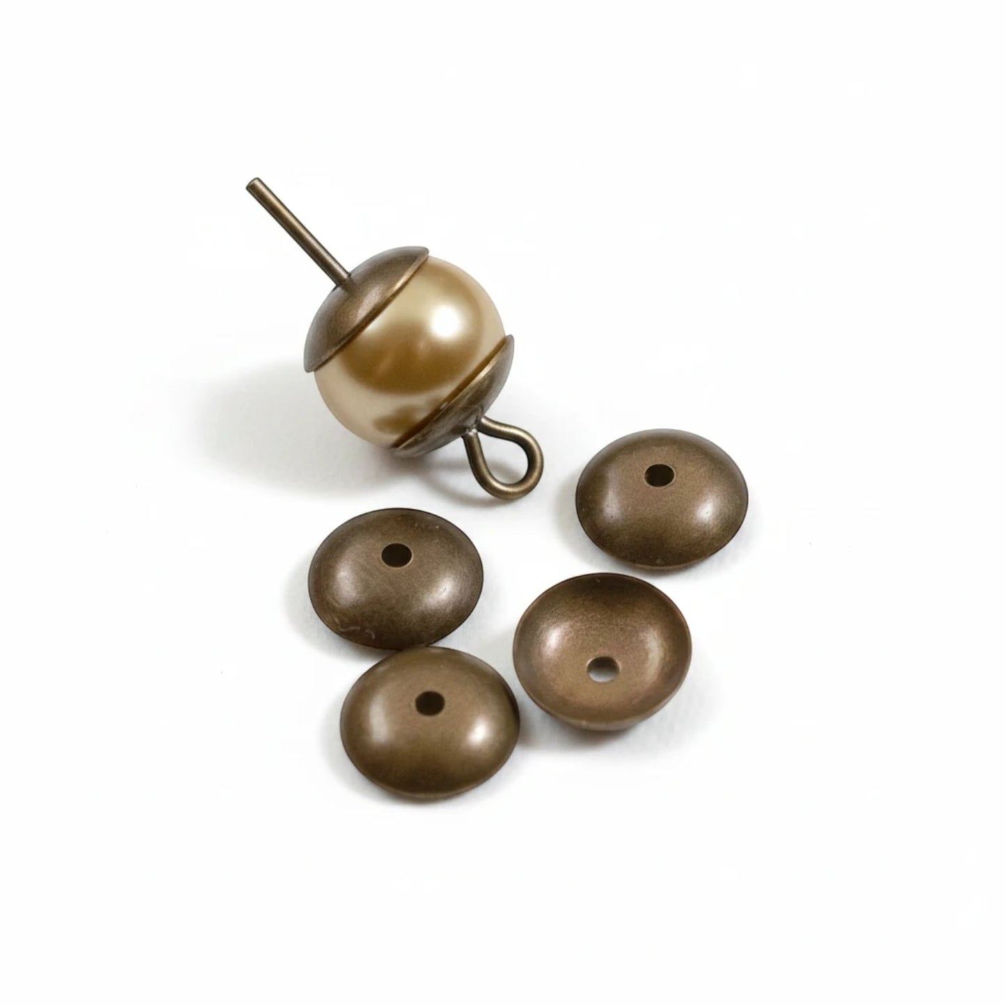 Hackberry Creek 7mm antiqued natural brass bead caps for jewelry making, shown with a bead on a headpin.