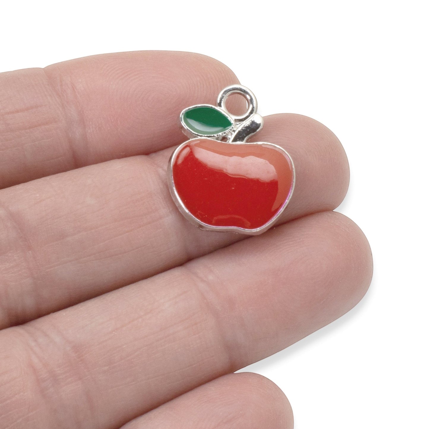 Hackberry Creek bright red enamel apple charm with green leaf detail, silver metal alloy, 21mm x 17.5mm, for jewelry making.