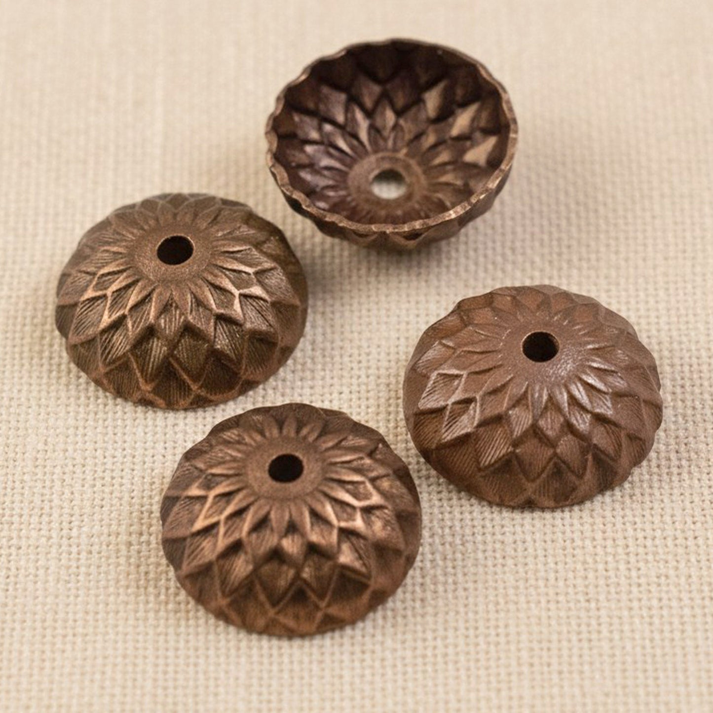 Hackberry Creek 12.5mm artisan copper acorn bead caps with a deep relief sunflower and petal design in a 4-pack