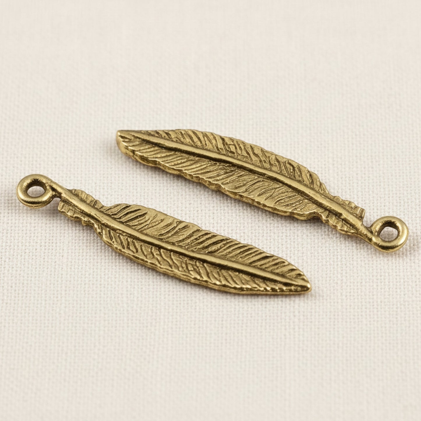 Hackberry Creek two 33mm gold 24K pewter feather charms with intricate detail and a loop for jewelry making.