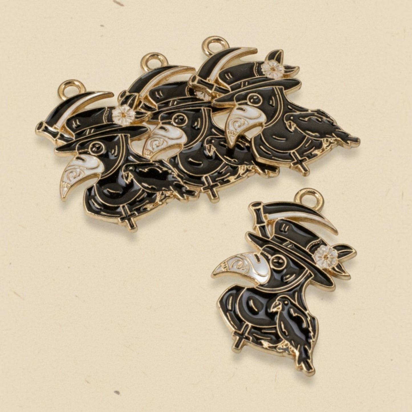 Hackberry Creek plague doctor raven head charms in black and white enamel with gold plating for gothic jewelry making.