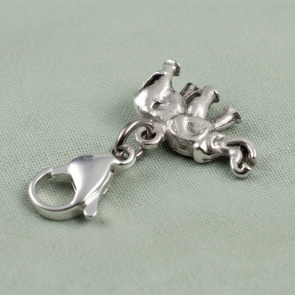 Hackberry Creek silver plated pewter elephant charm with a lobster clasp and detailed trunk-up design.
