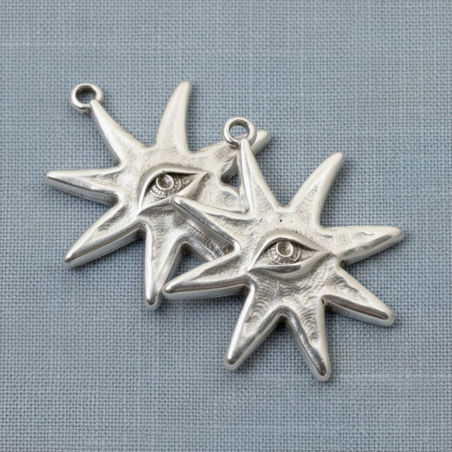 Hackberry Creek silver-plated star eye pendants featuring an intricate celestial design for jewelry making.