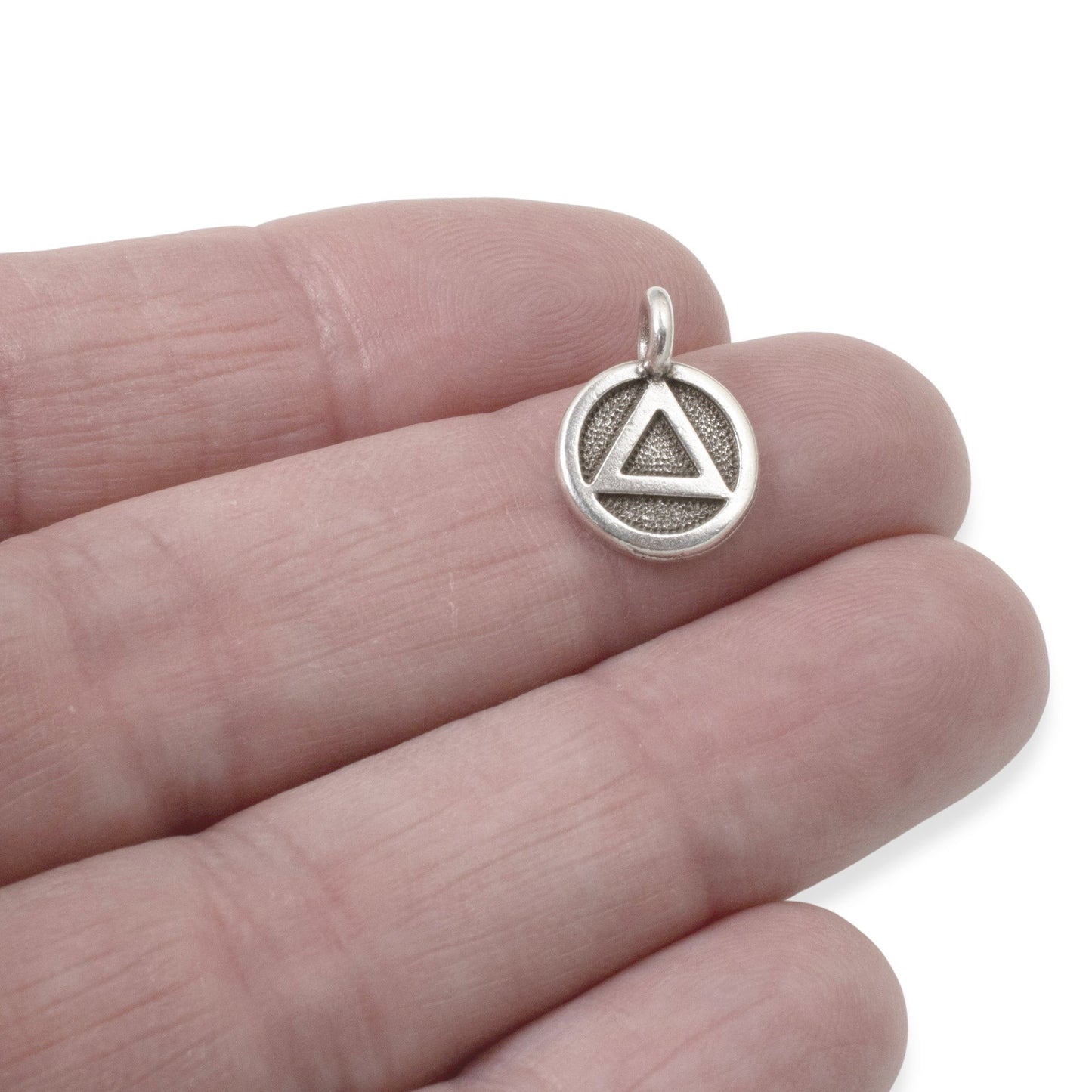 Hackberry Creek antique silver triangle recovery charm with sacred geometry symbol on a textured background, 12mm x 16mm.