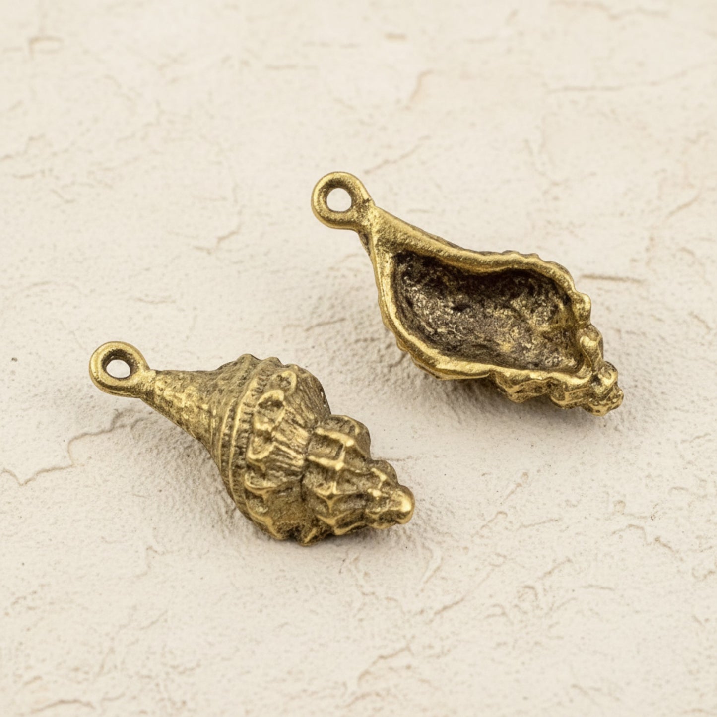 Hackberry Creek 24K gold plated pewter trumpet shell charms with intricate detailing, 21mm. Beach nautical jewelry.