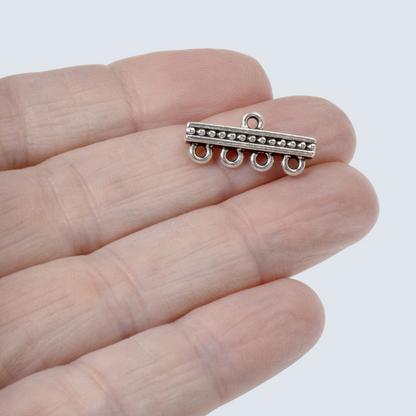 Hackberry Creek silver 4-to-1 beaded connector link held on a hand for multi-strand jewelry making