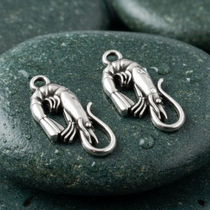 Hackberry Creek antique silver shrimp charms with detailed segmented bodies and tails, 10x22mm, sold in a 4-pack.