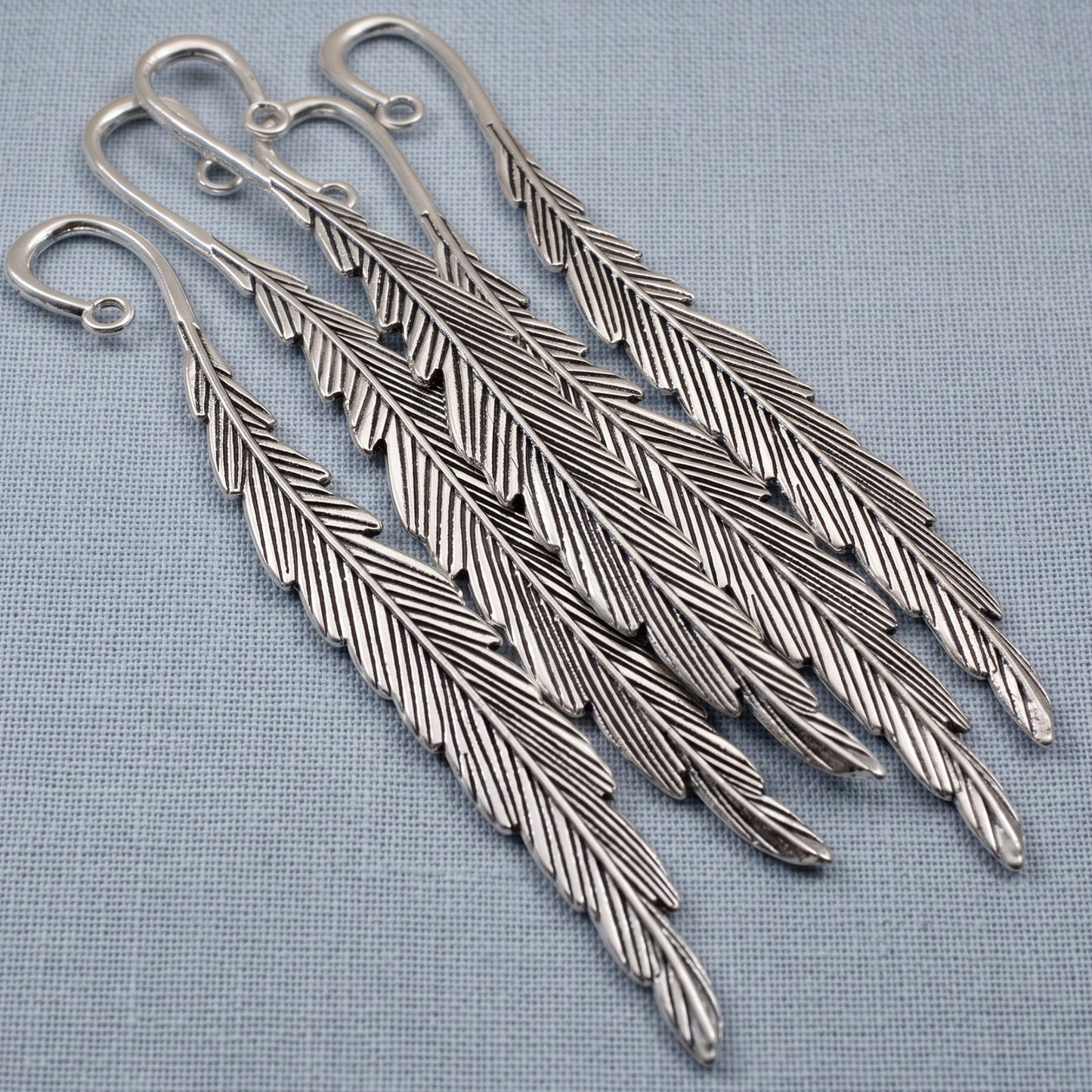 Hackberry Creek silver feather bookmark bases with etched detail and charm loops for DIY craft projects