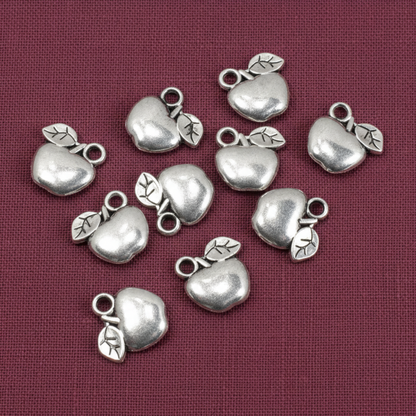 Hackberry Creek silver apple charms for jewelry making, crafted from zinc alloy with a shiny metallic finish.
