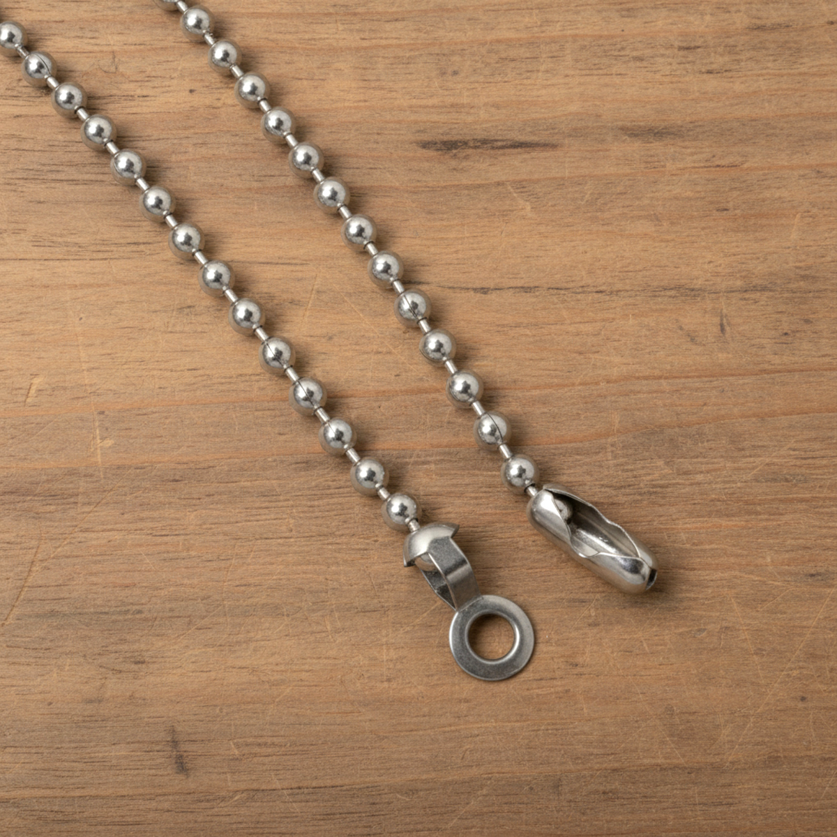 Hackberry Creek DIY ceiling fan pull kit with nickel-plated steel ball chain, connectors, and loop on wood surface