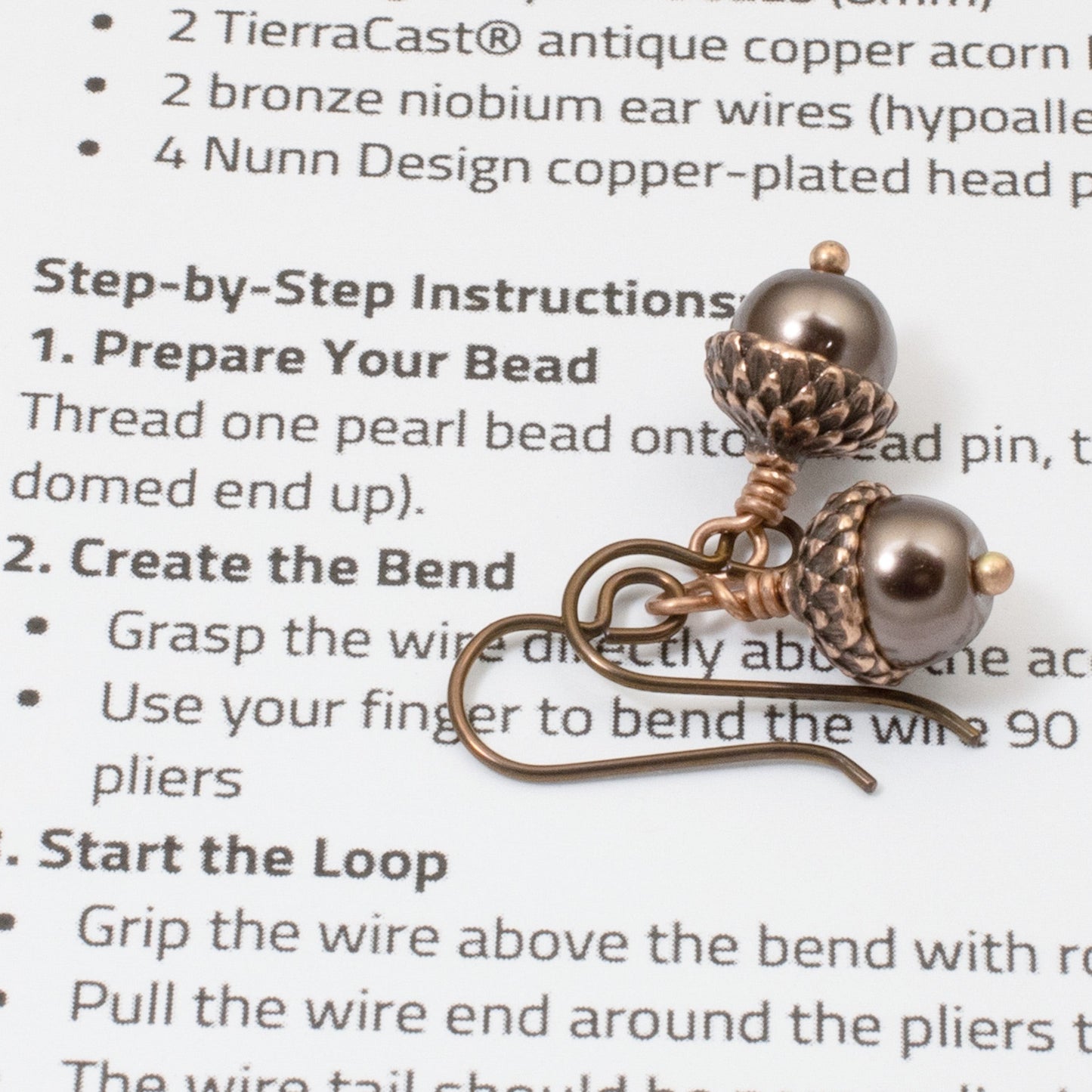 Hackberry Creek DIY earring kit with chocolate brown glass pearls and antique copper acorn caps. Hypoallergenic niobium hooks.