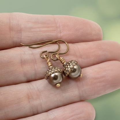 Hackberry Creek brown glass pearl and copper acorn cap earrings with hypoallergenic niobium hooks.