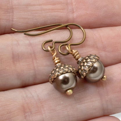 Hackberry Creek brown glass pearl and copper acorn cap earrings with hypoallergenic niobium hooks.