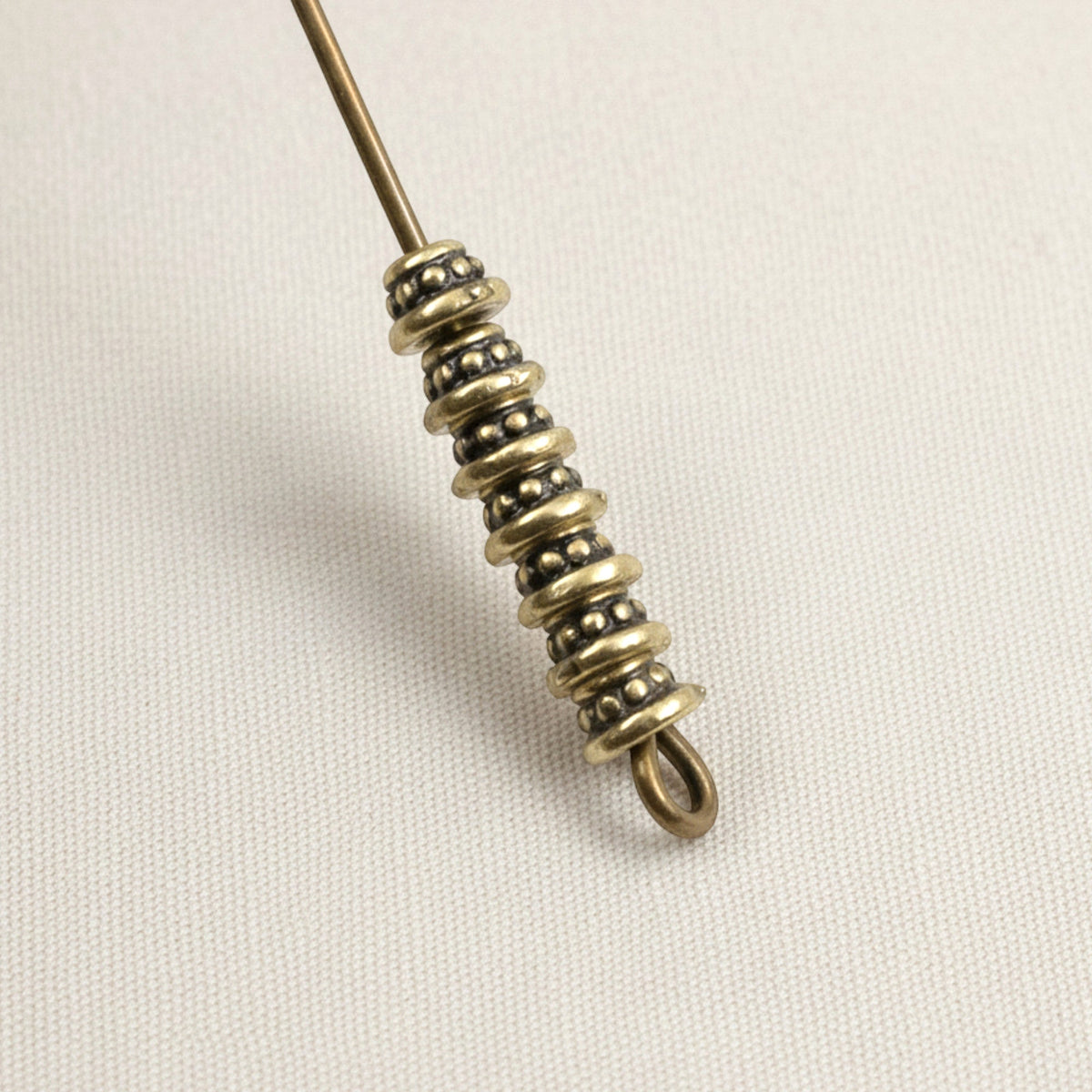 Hackberry Creek antique brass beaded bead caps on a wire, featuring a rustic vintage-style oxidized finish.
