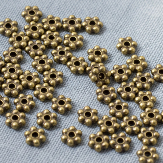 Hackberry Creek Antique Brass 3mm daisy spacer beads, 500 bulk pack, pewter with antique brass plating, designed by TierraCast.