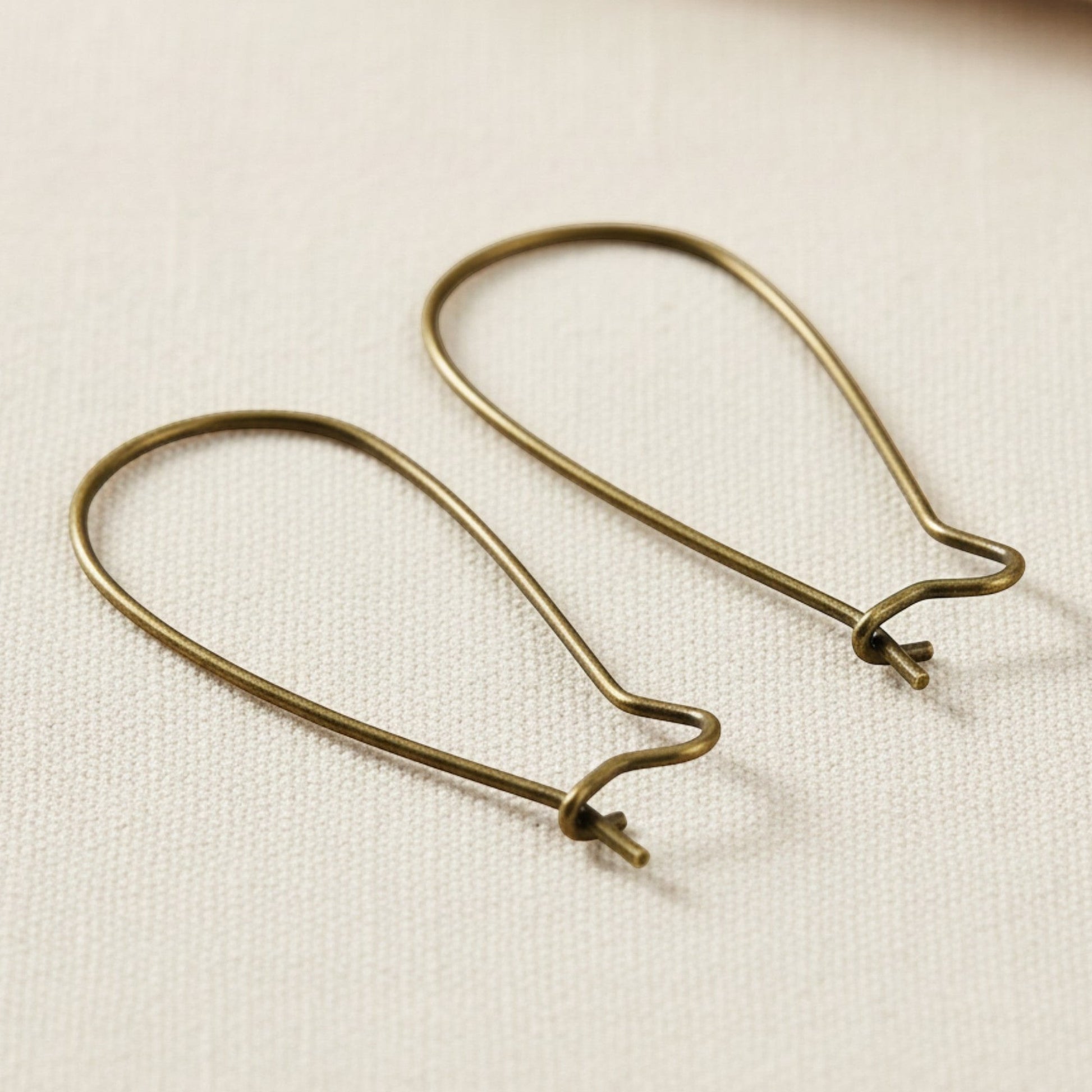 Hackberry Creek antique brass kidney ear wires, 33mm vintage boho earring findings with safety hook closure.