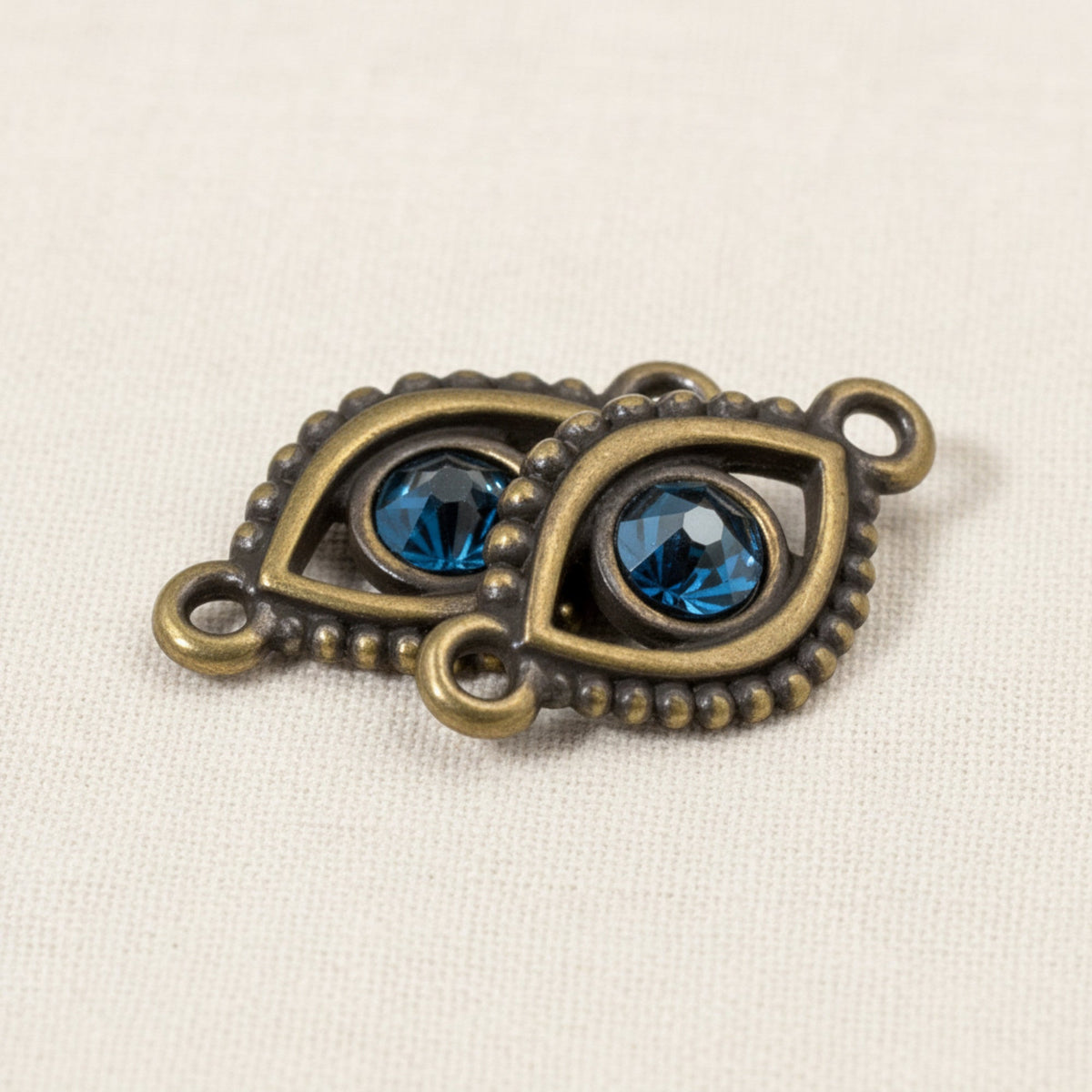 Hackberry Creek antique brass evil eye connector links with blue crystal accents for DIY jewelry making