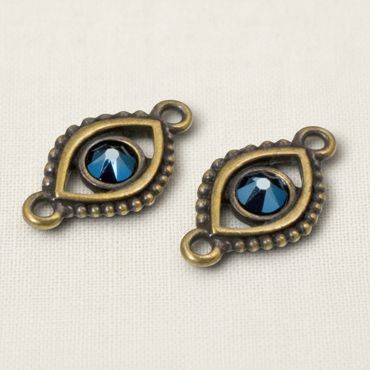 Hackberry Creek antique brass evil eye connector links with blue crystal centers for bohemian jewelry making