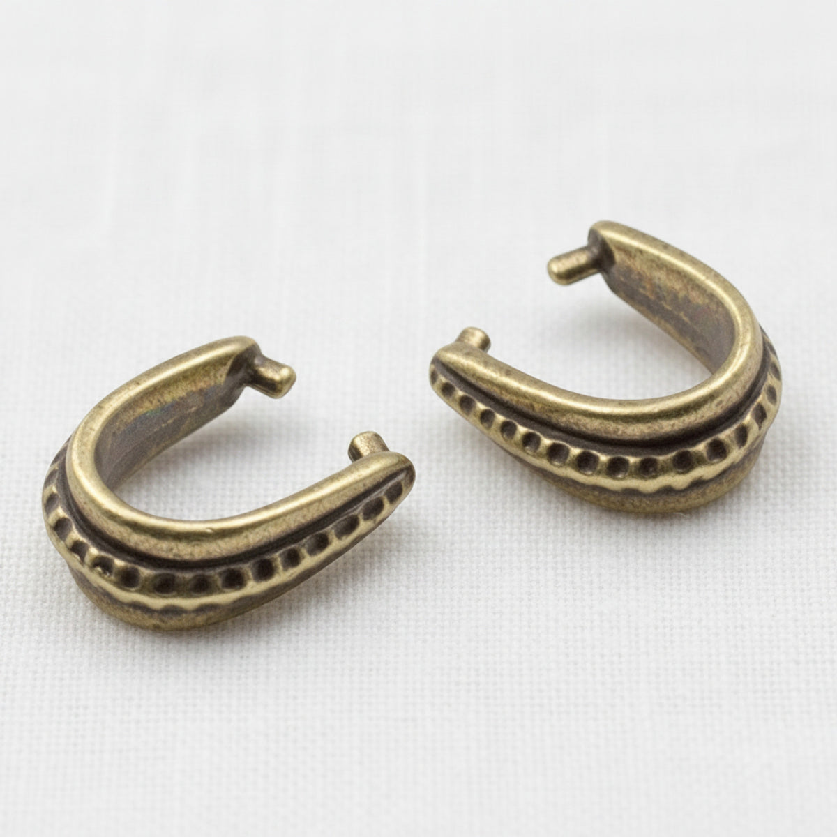 Hackberry Creek antique brass hammered pinch bails for jewelry making with vintage patina and textured detail