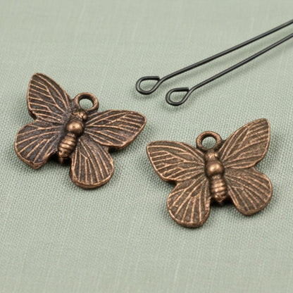 Hackberry Creek antique copper butterfly charms with detailed wings for rustic jewelry making, set of two.