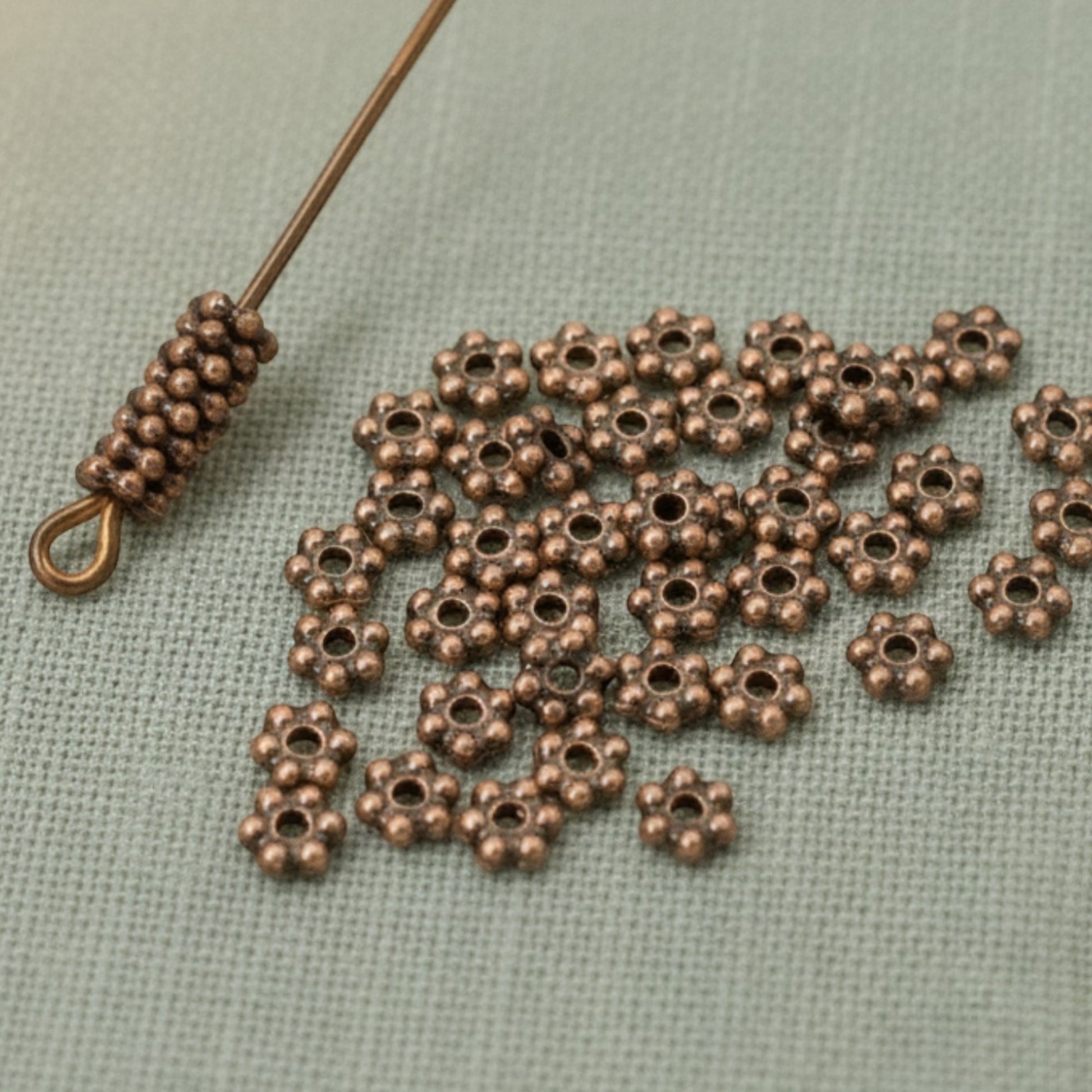 Hackberry Creek 50 antique copper 3mm daisy spacer beads, designed by TierraCast, made from lead-free pewter with copper plating.