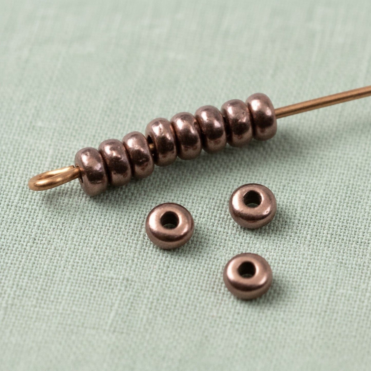 Hackberry Creek 50 antique copper 3mm disk spacer beads, smooth heishi style, for jewelry making.