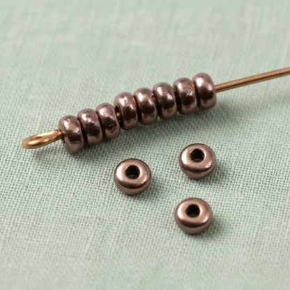 Hackberry Creek 50 antique copper 3mm disk spacer beads, smooth heishi style, for jewelry making.