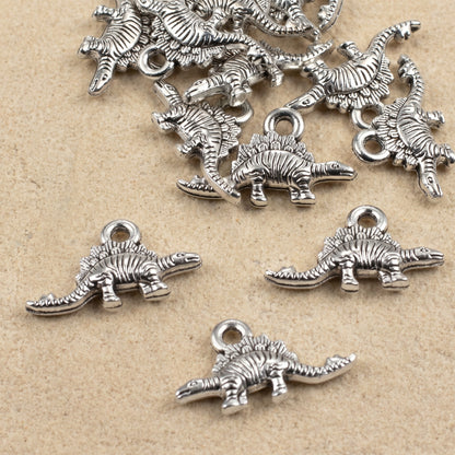 Hackberry Creek antique silver dinosaur charms for jewelry making, featuring detailed double-sided metal pendants.