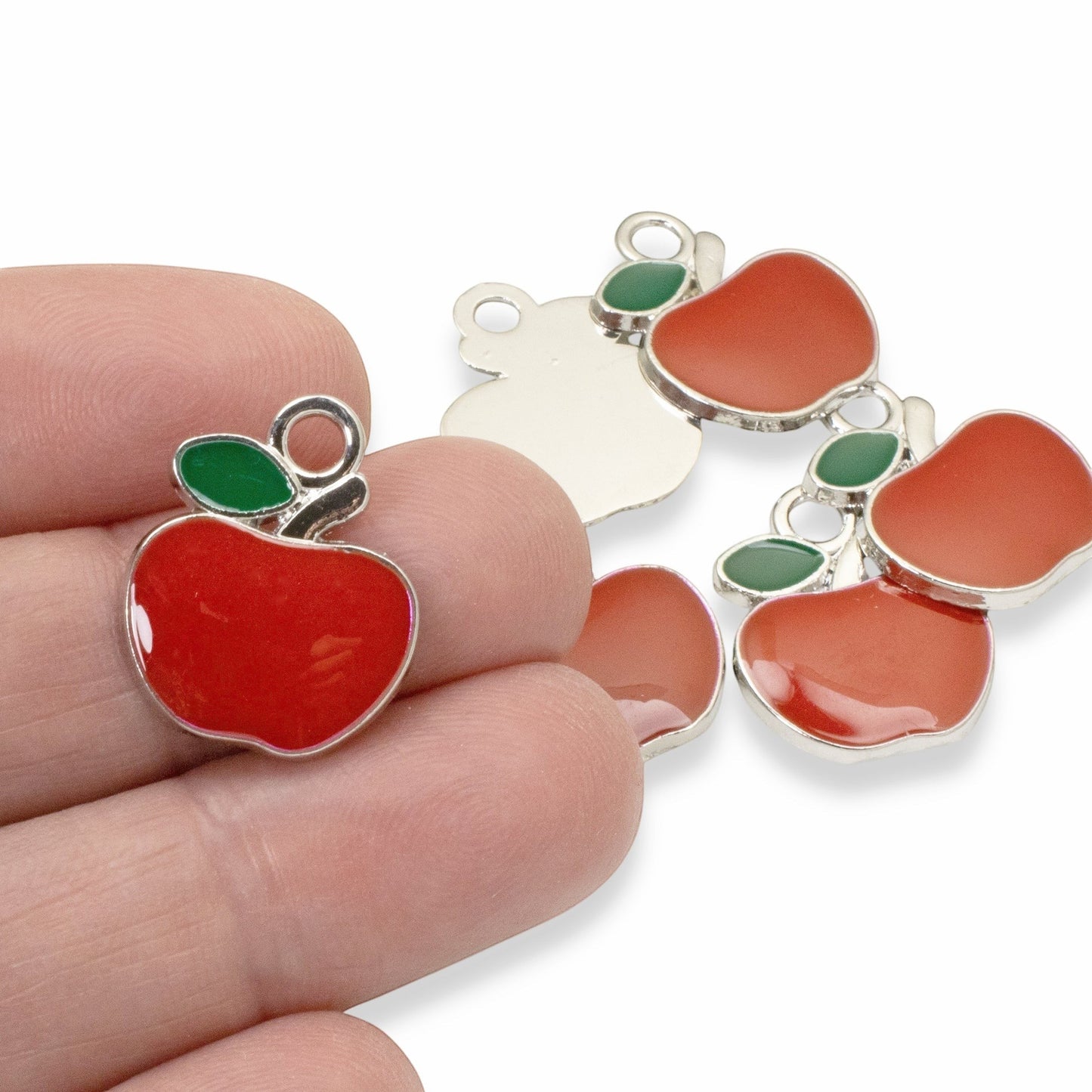 Hackberry Creek bright red enamel apple charms with green leaves, silver metal alloy, 21mm x 17.5mm, for jewelry making.
