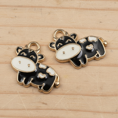 Hackberry Creek black and ivory enamel cow charms with copper outlines for farmhouse jewelry making