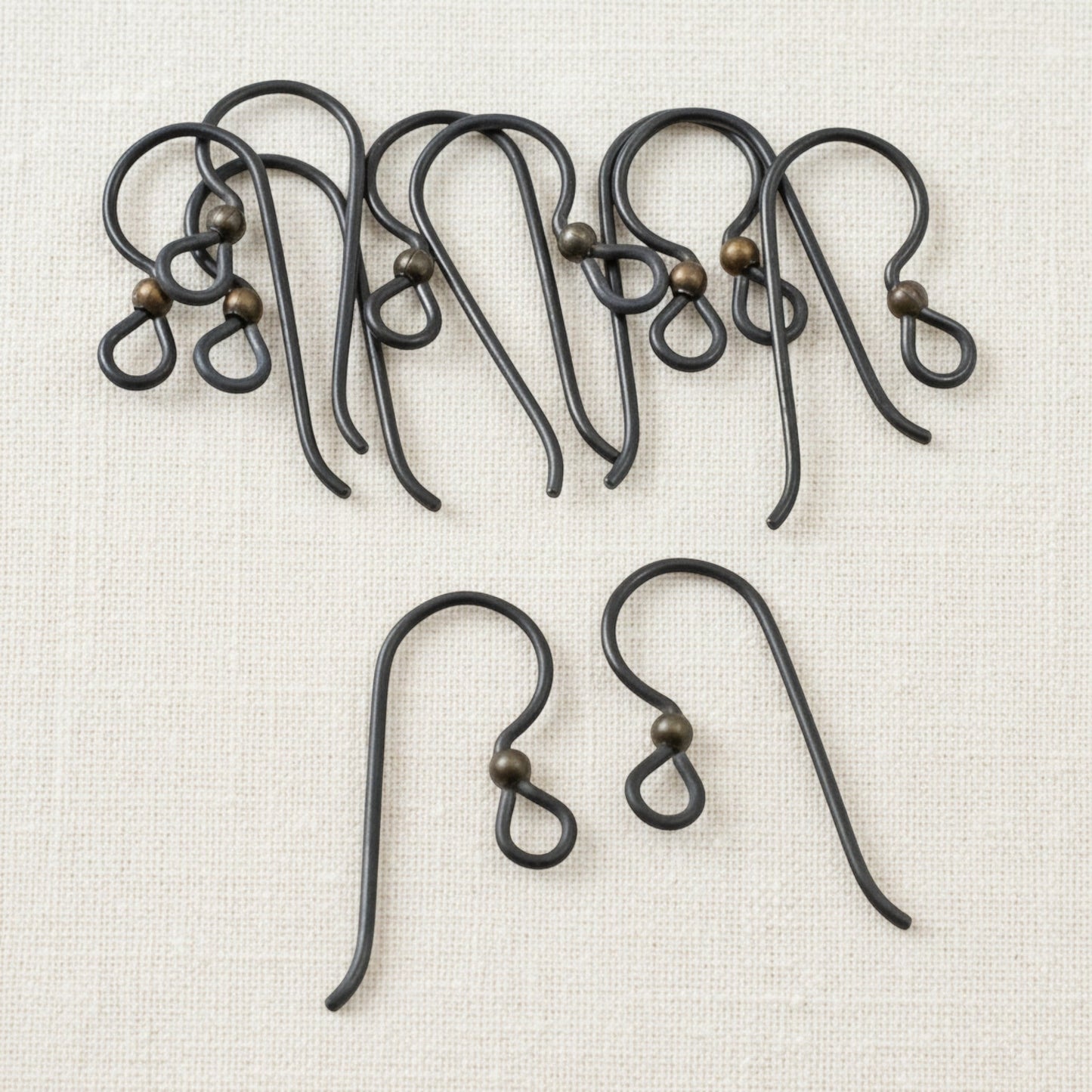 Hackberry Creek matte black niobium earring hooks with antique brass bead, 10 pack. Hypoallergenic for sensitive ears.