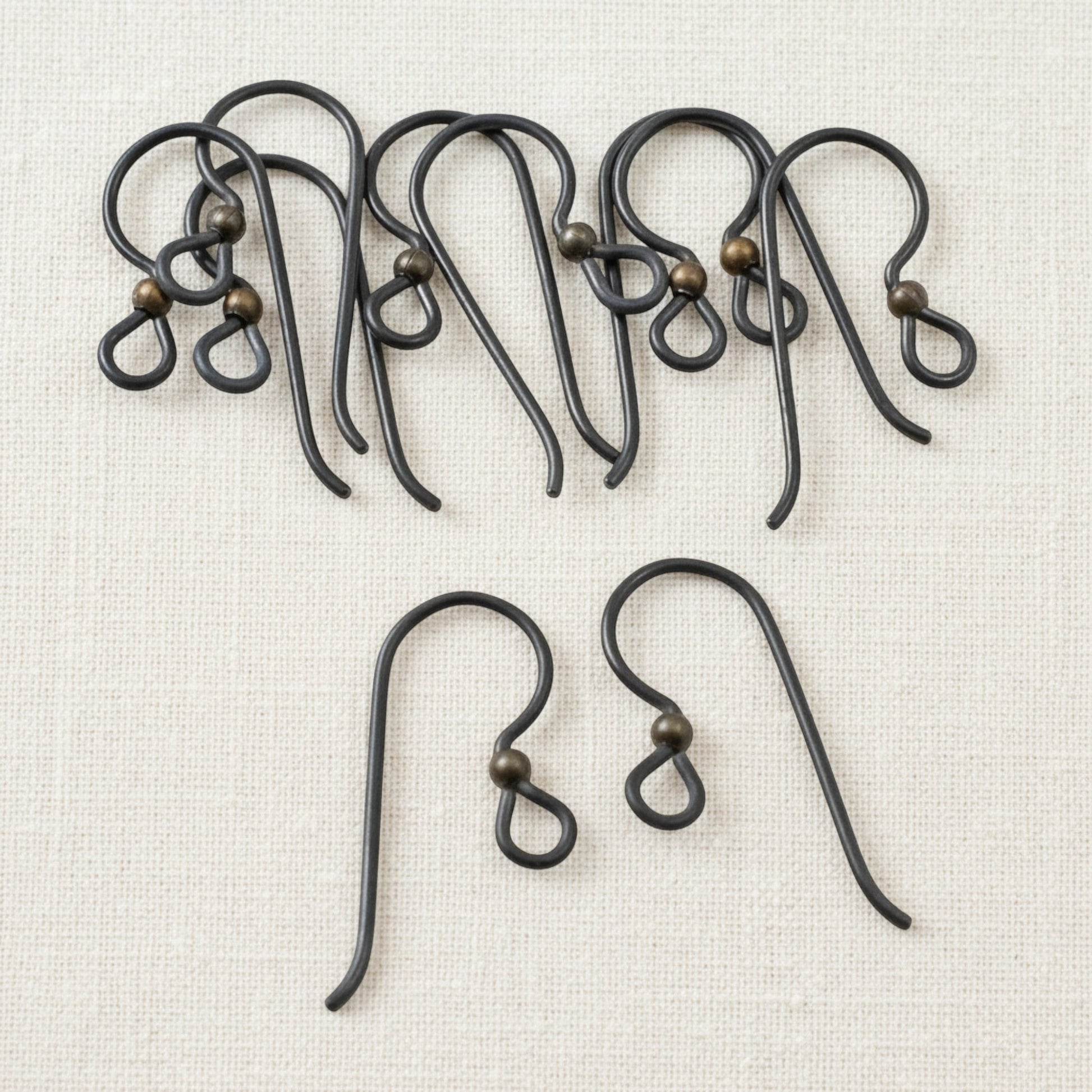 Hackberry Creek matte black niobium earring hooks with antique brass bead, 10 pack. Hypoallergenic for sensitive ears.