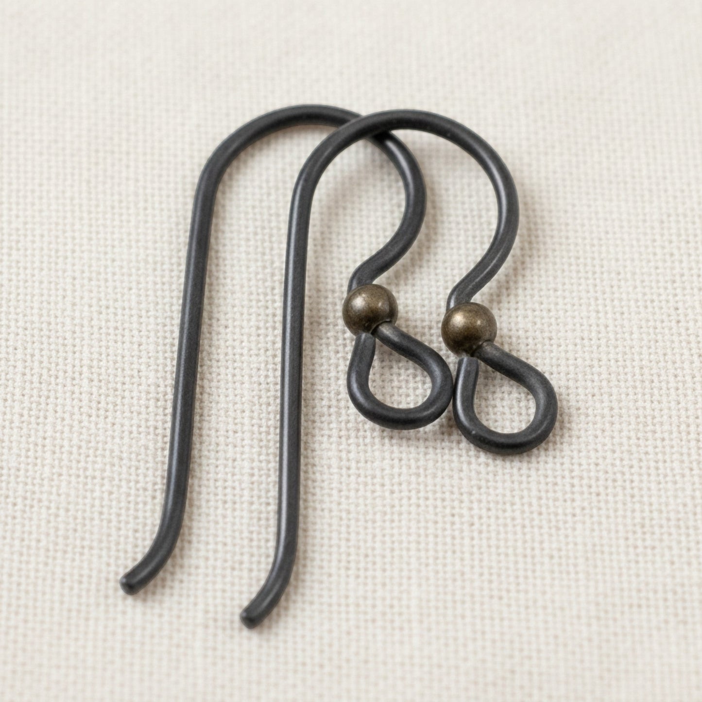 Hackberry Creek matte black niobium earring hooks with antique brass bead, 10 pack, for sensitive ears and vintage boho styles.