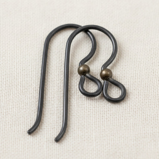 Hackberry Creek matte black niobium earring hooks with antique brass bead, 10 pack, for sensitive ears and vintage boho styles.