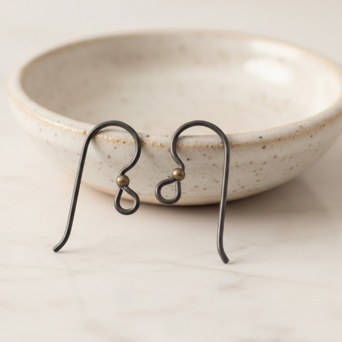 Hackberry Creek matte black niobium earring hooks with antique brass bead, 10 pack. Hypoallergenic for sensitive ears.