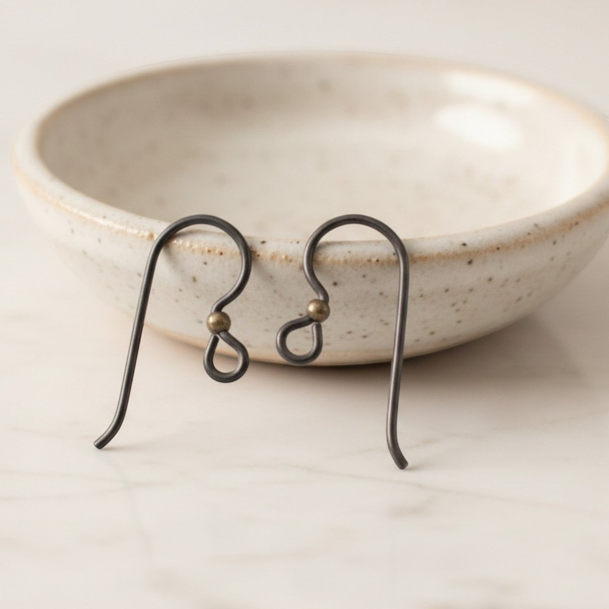 Hackberry Creek matte black niobium earring hooks with antique brass bead, 10 pack. Hypoallergenic for sensitive ears.