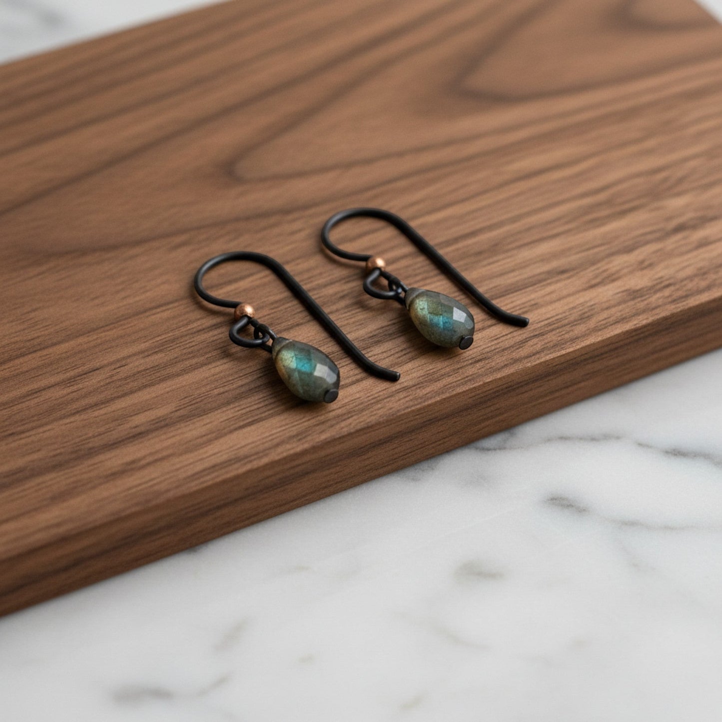 Hackberry Creek matte black niobium earring hooks with copper bead and faceted labradorite gems. Hypoallergenic, dark boho style.