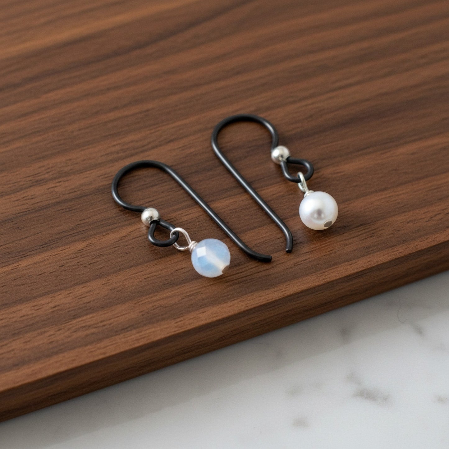 Hackberry Creek matte black niobium earring hooks with sterling silver bead and pearl or opal bead, hypoallergenic findings for sensitive ears.