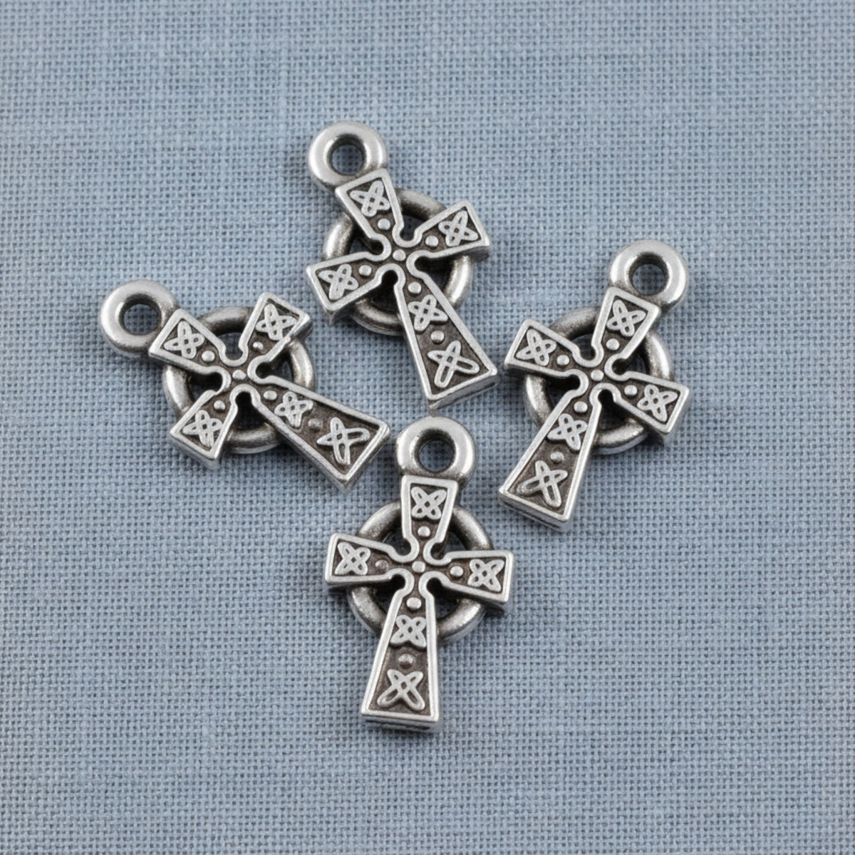 Hackberry Creek silver Celtic cross charms with detailed knotwork and antique finish, set of four for jewelry making.