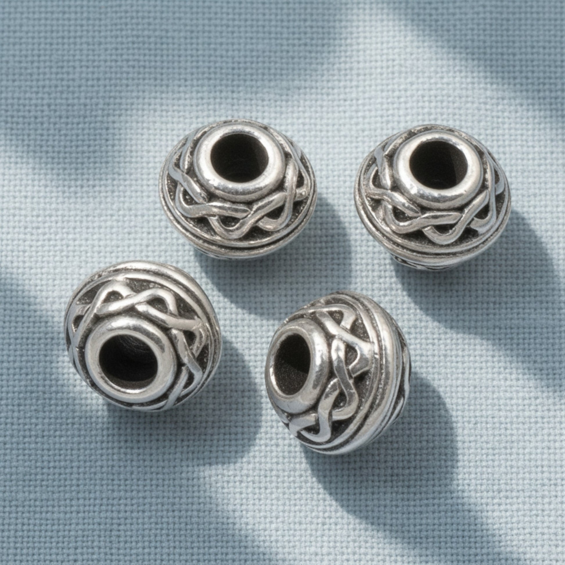 Hackberry Creek antique silver rondelle beads with Celtic rope pattern and 3mm hole for leather cord jewelry.