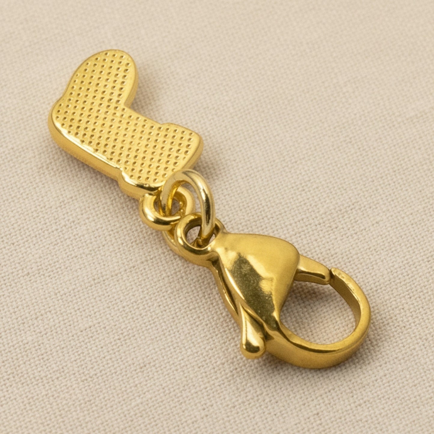 Hackberry Creek gold-plated Christmas stocking charm with a lobster clasp for bracelets, bags, or holiday jewelry.