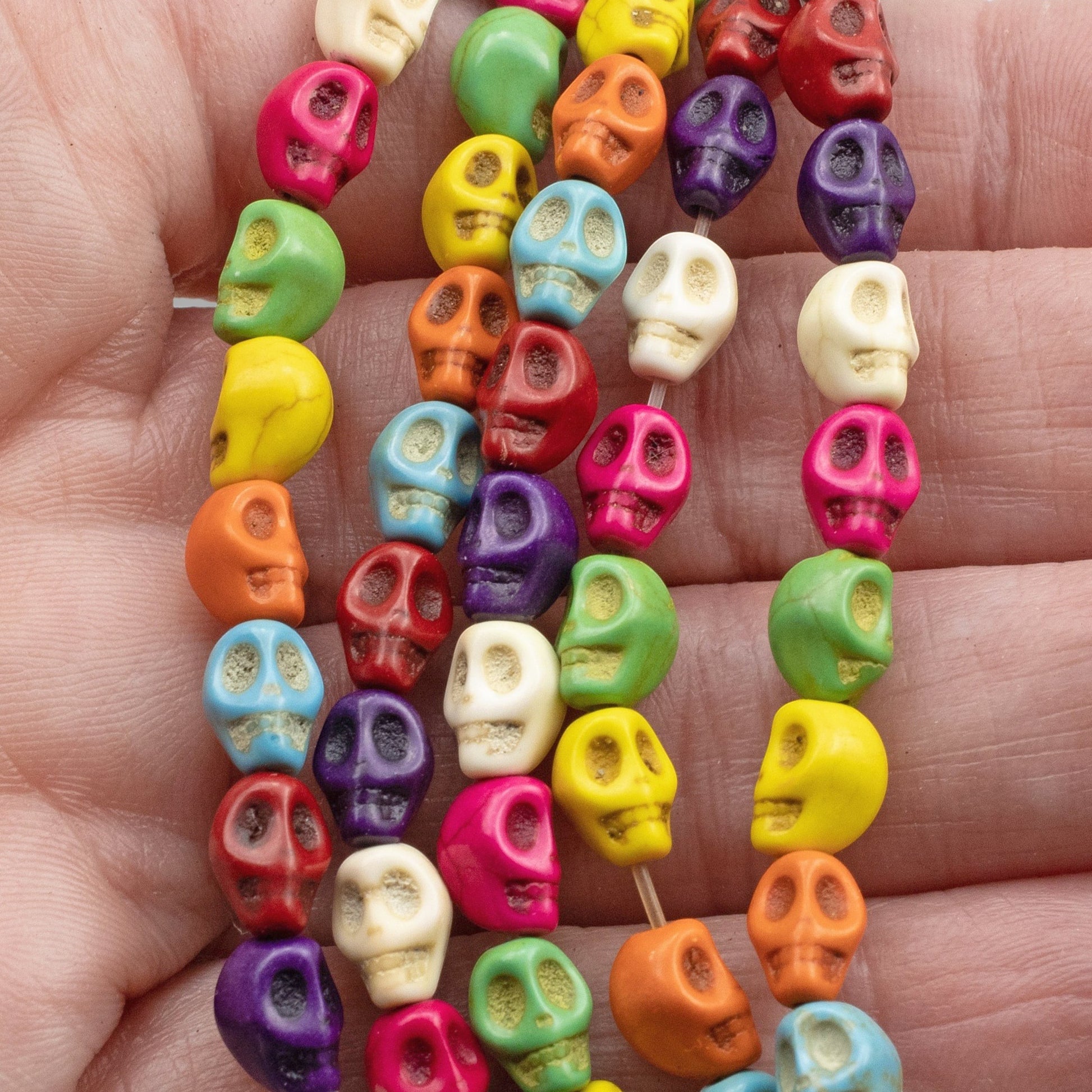 Hackberry Creek colorful magnesite skull beads on a 15-inch strand for DIY Halloween and Day of the Dead jewelry.