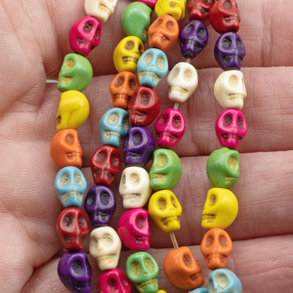 Hackberry Creek colorful magnesite skull beads on a 15-inch strand for DIY Halloween and Day of the Dead jewelry.
