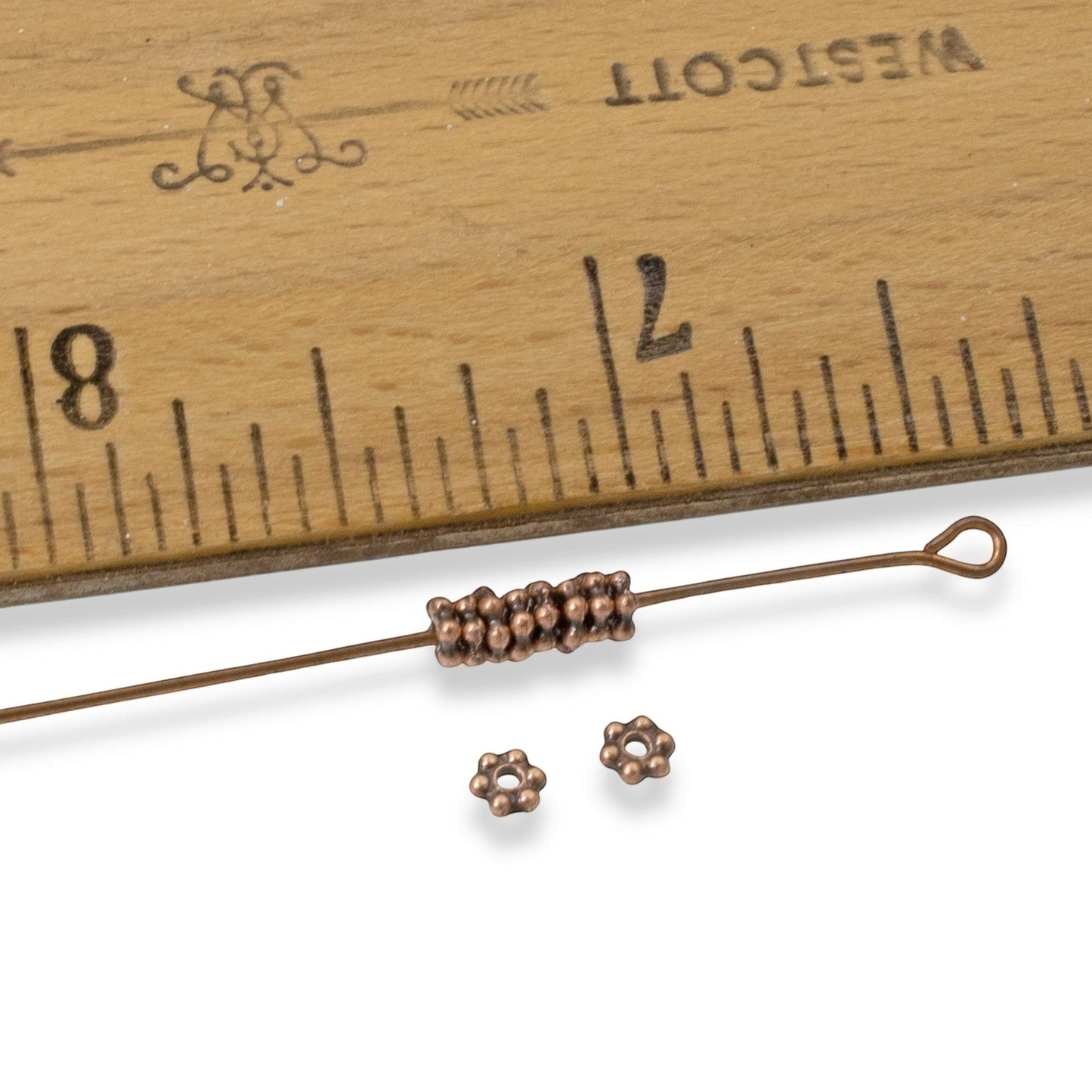 Hackberry Creek antique copper 3mm daisy spacer beads, 500 bulk pack. Tiny heishi flower design, pewter with antique copper plating.