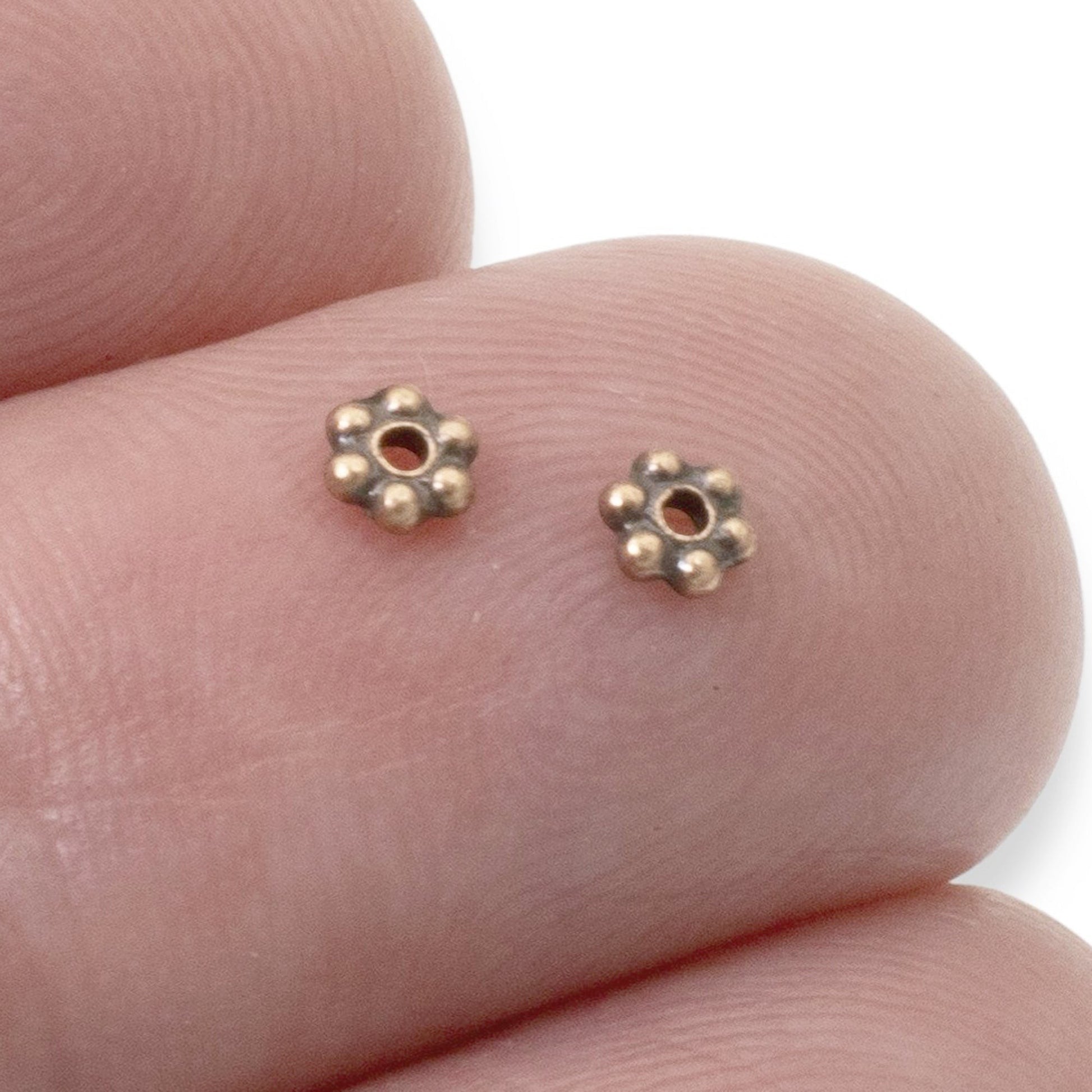Hackberry Creek antique copper 3mm daisy spacer beads with a TierraCast design, perfect for boho jewelry.
