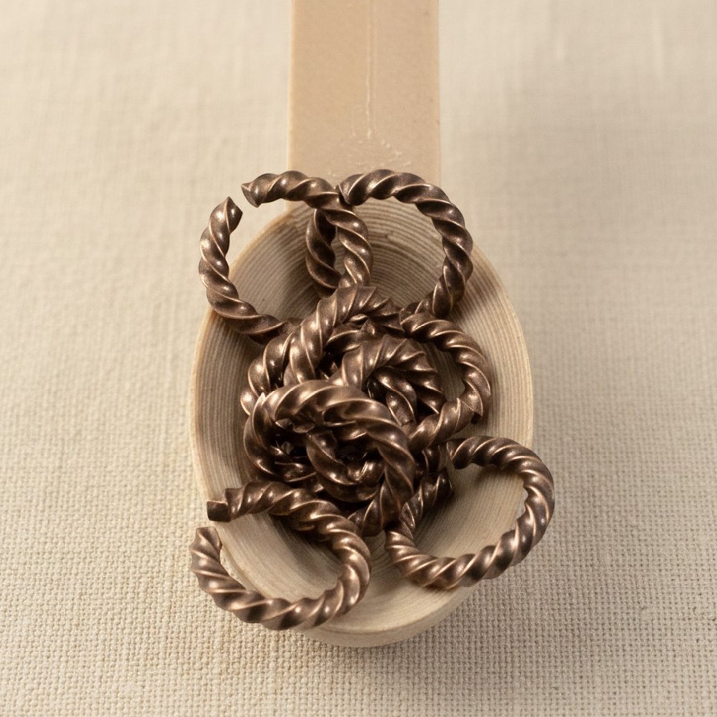 Hackberry Creek 14 gauge copper rope jump rings with twisted artisan charm connector style, 10 pack.