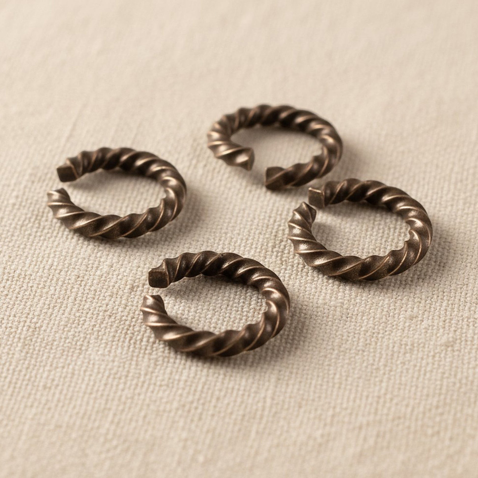 Hackberry Creek antique copper twisted rope jump rings, 14 gauge, 11.3mm outside diameter, 10 pack. Ideal for jewelry making.