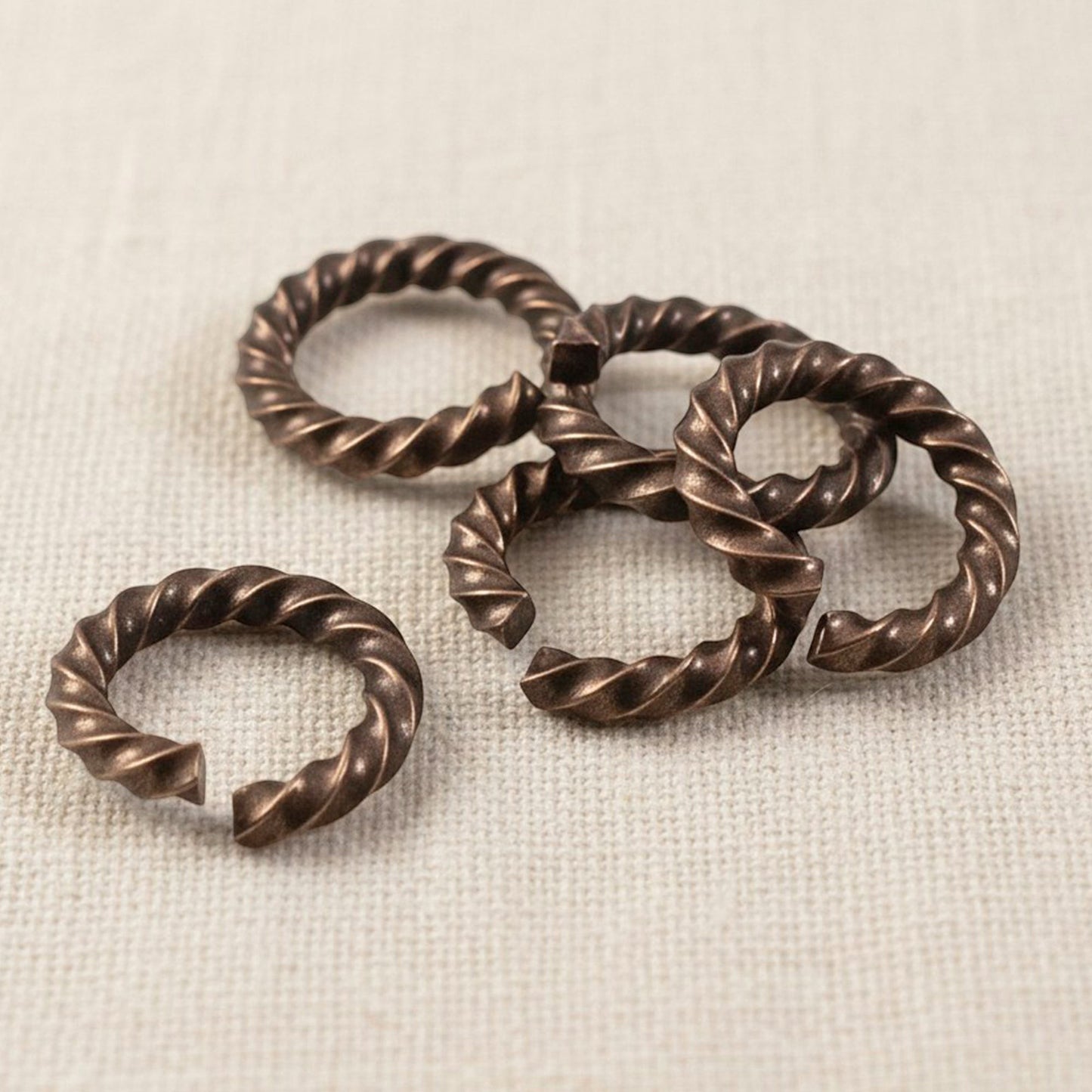 Hackberry Creek antique copper twisted rope jump rings, 14 gauge, 11.3mm outside diameter, 10 pack.