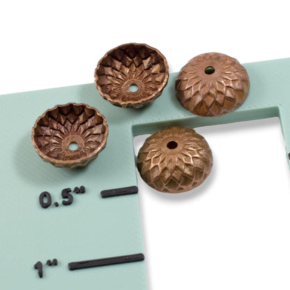Hackberry Creek 12.5mm artisan copper acorn bead caps with a deep relief sunflower and petal design.